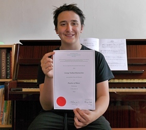 George Bournoxtsis, piano student, Melbourne, with his AMEB certificate