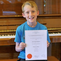 Luke Mathews, piano student, Melbourne, with his AMEB certificate